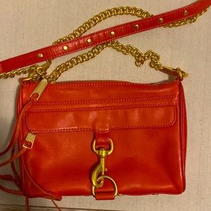 Rebecca Minkoff red leather hand bag with gold hardware trim.
